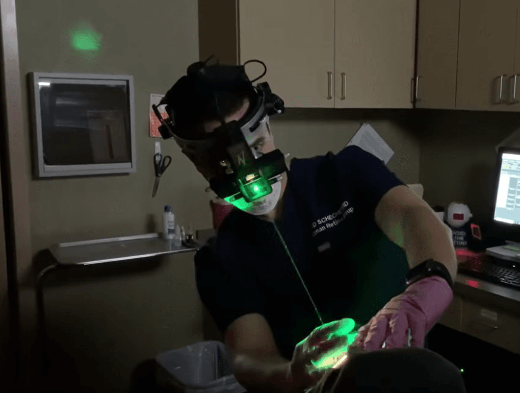 Dr. Schechet performing precision retinal laser treatment using an indirect ophthalmoscope
