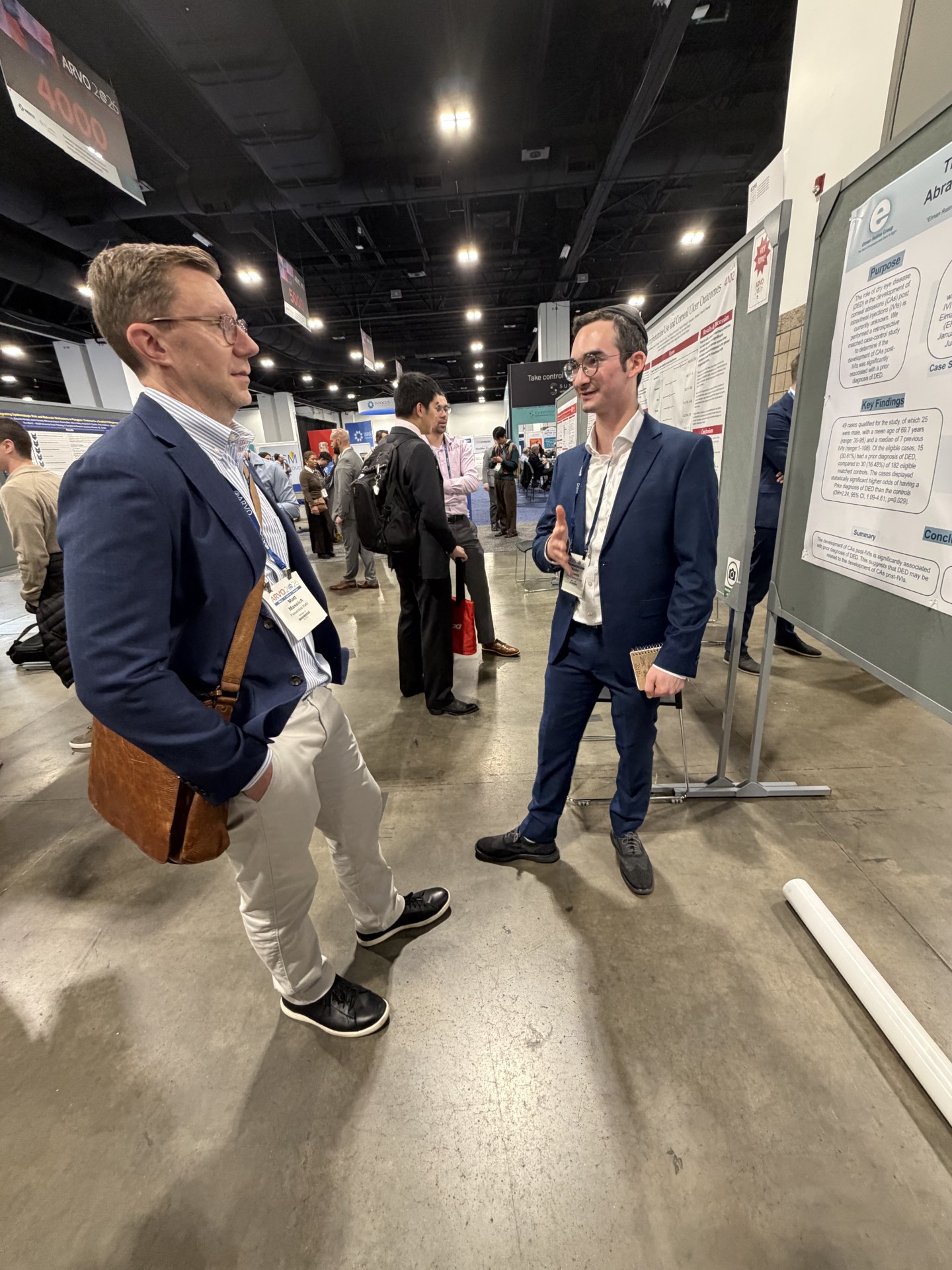 Moshe Horowitz discussing research findings with an attendee at the ARVO 2026 poster session